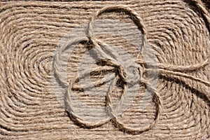 Background made of natural string with a charming flower.