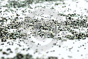 A background made out of strewn inside an activated carbon filter and water filter balls,  on a white background, selectiv