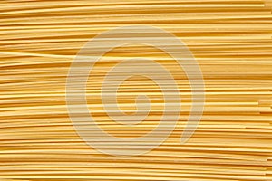 Background made of raw pasta stacked horizontally