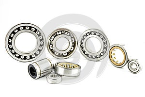 Background made of several ball bearings, isolated on a white background, selective focus, in the background the bearings standing
