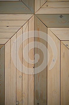 The background is made of wooden boards arranged diagonally. The boards have a different color of painting. Vertical photo