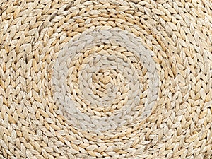 Background is made of woven straw. Circular pattern