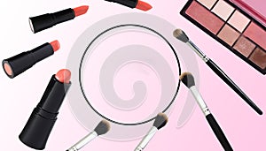 background makeup, lipstick, brush for powder and powder, circle in the middle as copy space, pink-white background