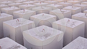 Background of many Concrete Anchors for posting Undersea Mooring Buoys on industrial yard in symmetric perspective view