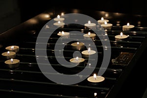 Background of many lit candles in basilica photo
