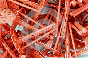 Background of many red plastic dowels for thermal insulation.