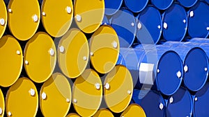 Background of many yellow and blue 200 liter oil drums stacked in perspective side view