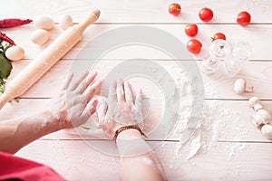 Background of men's hands knead the dough