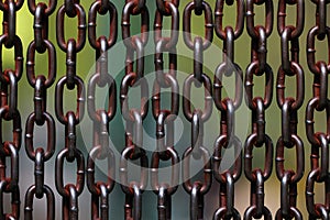 Background of metal chains, old used chain. Metal curtain on the entrance of bird park. The door made of chain link to