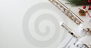 Background with metal flute on white table and Christmas decoration