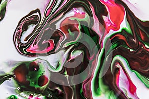 Background of milk and colored diluted paints in it