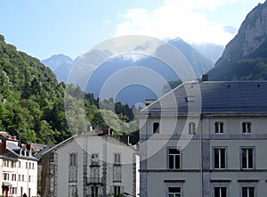 Village in the french pyrenees with veils of mist on the mountains tops