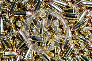 Background of 9mm bullets jumbled together photo
