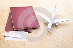 background with a model airplane and lying next to airline tickets and passports on a wooden table with copy space