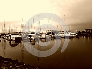 Background of moored yatchs in evening light with reflections on water photo