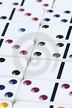 Background of multicolored domino bones in macro photograph.