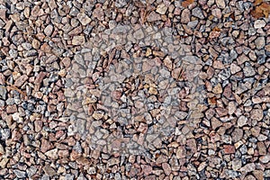 Background of natural grey granite crushed stone, macadam. Macro photo of texture of broken stone or rubble with place
