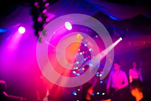Background in night club atmosphere with people and lasers at party