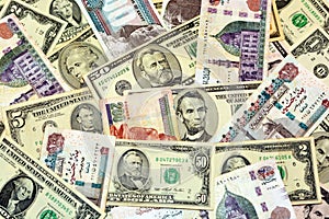 A background of old American money banknotes USD United States of America dollars bills and Egyptian pounds