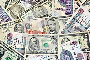 A background of old American money banknotes USD United States of America dollars bills and Egyptian pounds