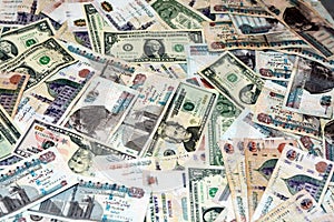 A background of old American money banknotes USD United States of America dollars bills and Egyptian pounds