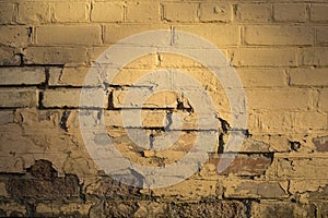 Background of old brick wall with falling off brown paint. Old vintage brick wall pattern. Brick texture