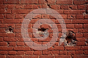 Background old brick wall with holes of bullets