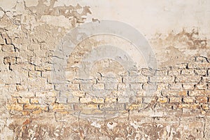 Background of old brickwall, texture of an worn facade made of bricks and mortar photo