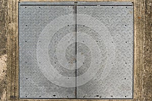 Background of Old metal diamond plate on concrete floor