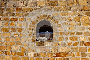 Background of old stone wall with a loophole photo