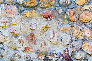 Background of old stone wall texture photo. Colorful old stone wall