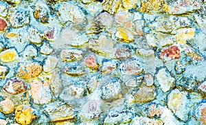 Background of old stone wall texture photo. Colorful old stone wall