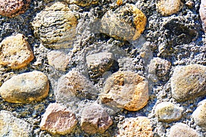 Background of old stone wall texture photo. Colorful old stone wall