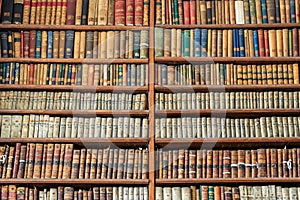 Background of old vintage books on wood bookshelf in a library