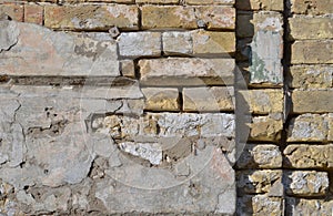 Background of old vintage dirty brick wall with peeling plaster, texture. Copyspace