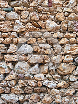 Background of old wall of stone and mud. Rustic stone facade. Constructions and Architecture