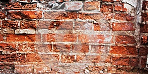 Background of old weathered red brick wall texture closeup