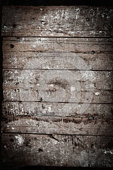 Background of old worn with shabby white paint connected to the shield of wooden boards