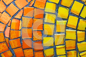 Background from orange and red matte mosaic. Painting of orange street mosaic. Orange and yellow patterned mosaic background
