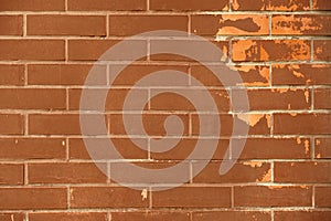 Background of ordinary brown brick wall with scrapes paint