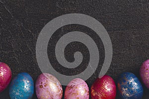 Background of painted colorful Easter eggs with golden spots