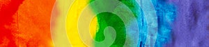 Background painted in rainbow LGBTQ flag. Hand drawn watercolor. LGBT + community, tolerance, pride month concept. Web banner.