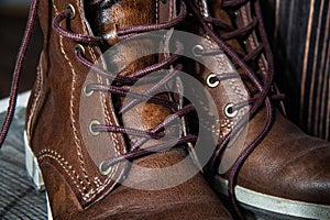 Background of pair or couple Close up view of brown leather man or woman new dry clean shoes, showing laces in detail.