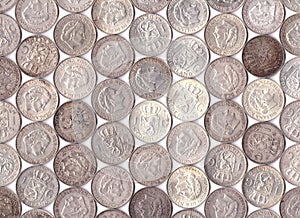 Pattern of old Dutch silver guilders on white photo