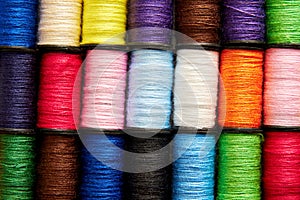 Background pattern of set of colorful rainbow sew thread spools