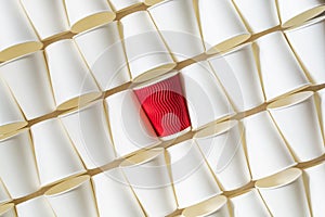 Background pattern of white paper cups with red cup in the middle