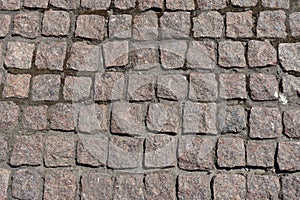 Background - pavement made of pink granite stone setts