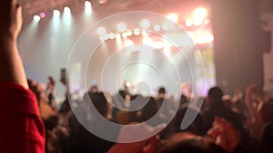 Background people acoustic stadium night music front holding hand up. asian crowd back adult woman man
