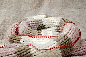 Background for photo collage on Christmas or winter theme for postcard, with knitted scarf with beads, it is curled