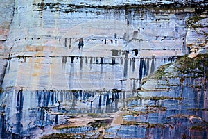 Background Pictured Rocks with minerals dripping like paint down stone cliff face